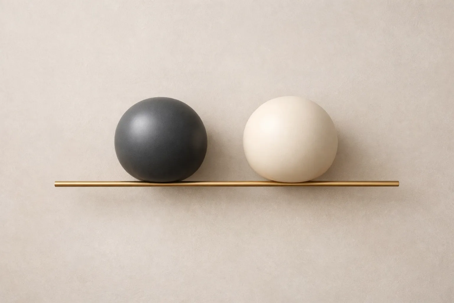 Two balanced spheres on a brass rail symbolizing shared standards and individual sovereignty in partnership.